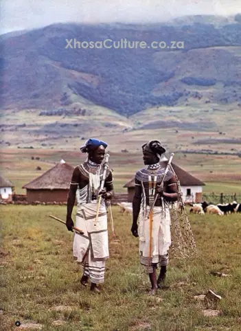 Xhosa-men-in-tradional-clothing-talking-in-a-village-mountains-behind